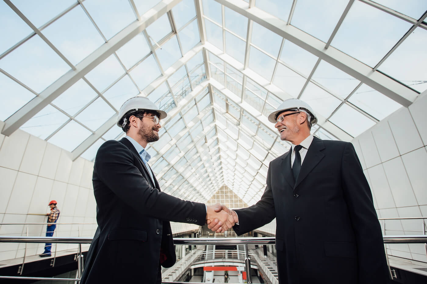 construction men in suits shaking hands